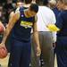 Michigan sophomore Trey Burke laughs as he jokes around with assistant coach Jeff Meyer during practice at the Palace on Tuesday, March 20, 2013 in Auburn Hills.  Melanie Maxwell I AnnArbor.com